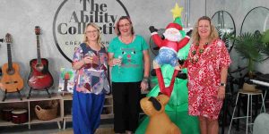 Ladies standing next to inflatable Christmas tree
