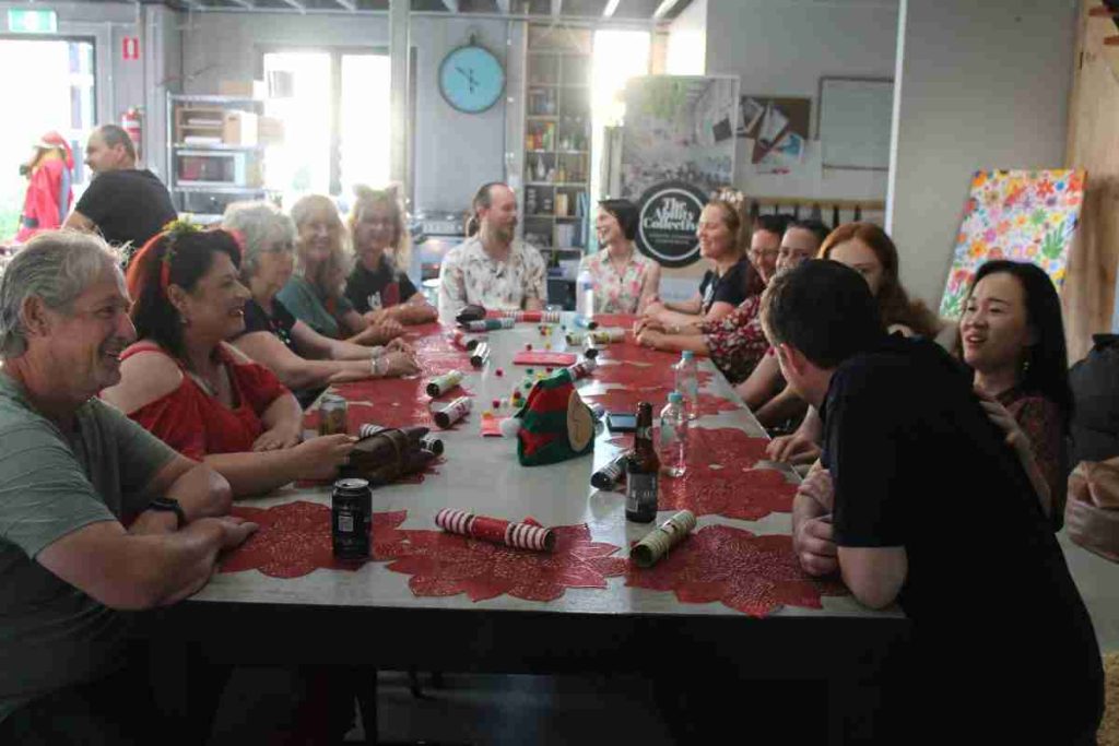 A long table with people sitting along each side.