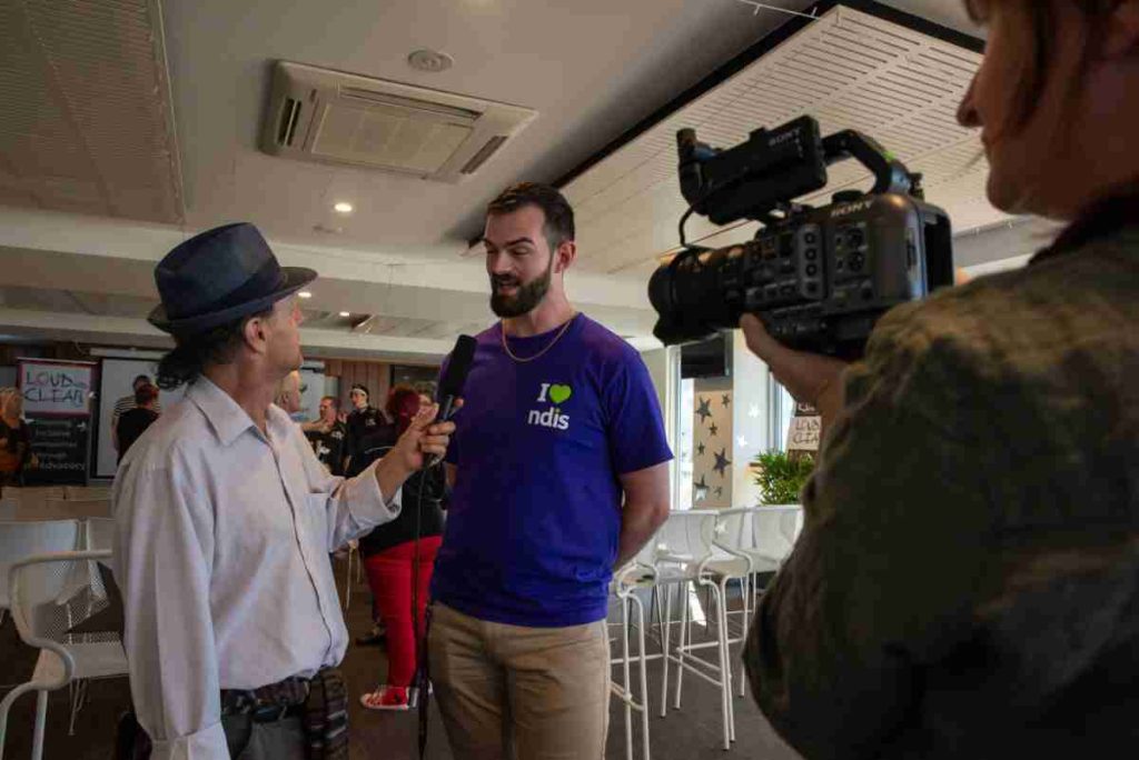 Man being interviewed and recorded