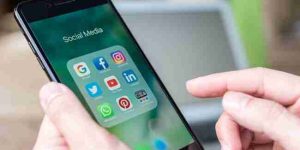 A phone open with several social media app icons on the screen.