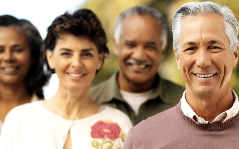 A group of 4 people smiling at the camera