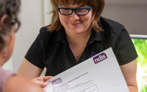 A woman discussing NDIS with another woman